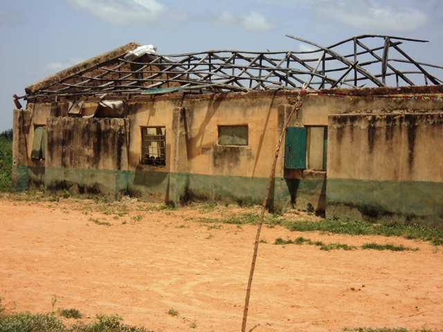 Collapsed roof and broken desks in a Kebbi primary school classroom