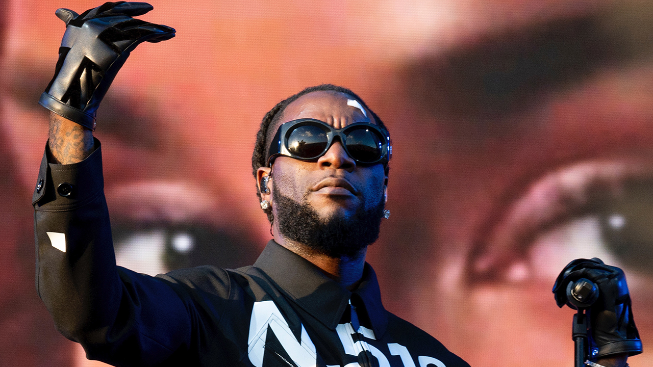 Burna Boy performing energetically on stage at Glastonbury Festival 2024