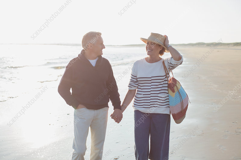 Mature couple holding hands and smiling