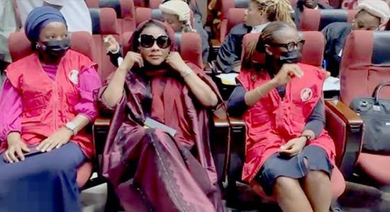 Aisha Achimugu escorted by EFCC operatives at Abuja airport